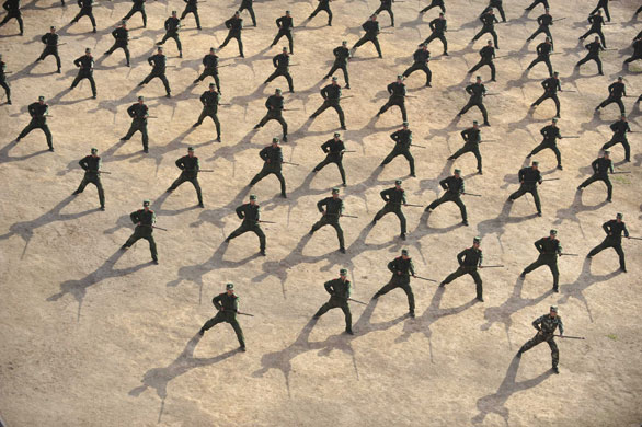 24 hours : Paramilitary recruits attend a training session at a military base in Wuhan
