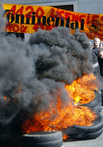 French strike: Continental employees set tyres alight during a demonstration in Compiegne