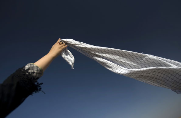 24 hours in pictures : Iranian woman attends a war memorial site  