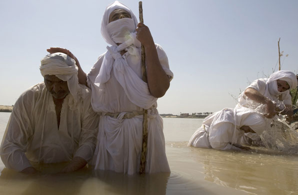 24 hours in pictures : Mandaean priests baptize worshippers in the Tigris river  