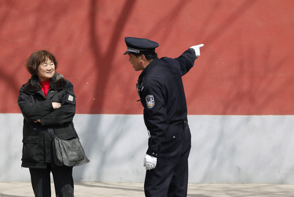 24 hours in pictures : A Chinese policeman argues with a protestor  in Beijing