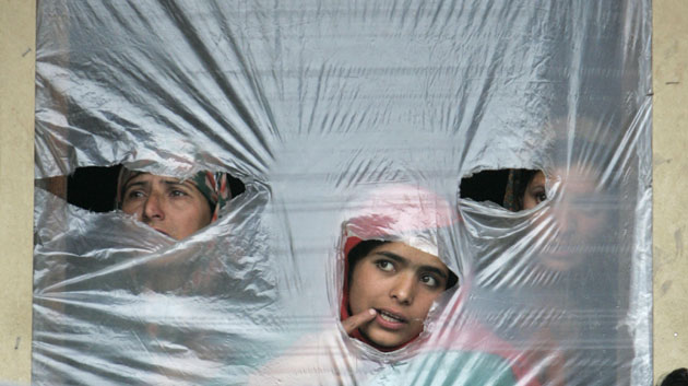 24 hours in pictures : Kashmiri women watch funeral in Pakharpora