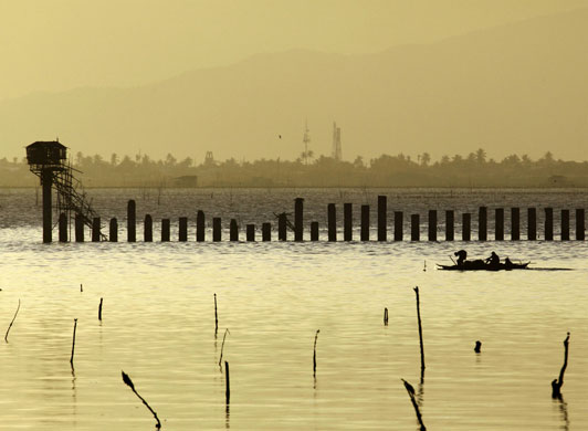 2 March 2009: Cavite, Philippines: Fishermen make their way home
