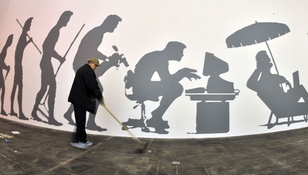 2 March 2009: Hanover, Germany: A man cleans an exhibition stand at the CeBIT