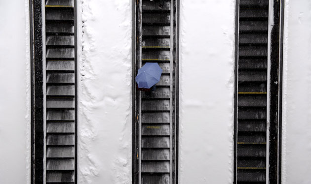 Snowstorm in US: A commuter on the escalator into a Metro Train station in Washington