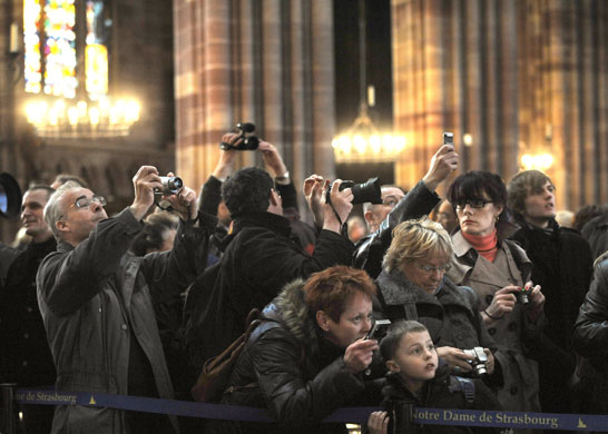 20 March 2009: Tourists watch for a green shaft of light in Strasbourg's cathedral