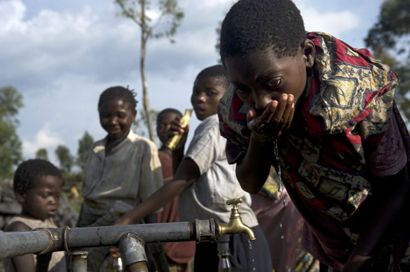24 hours: Congolese refugee drinks water from a tap in Kivu refugee camp