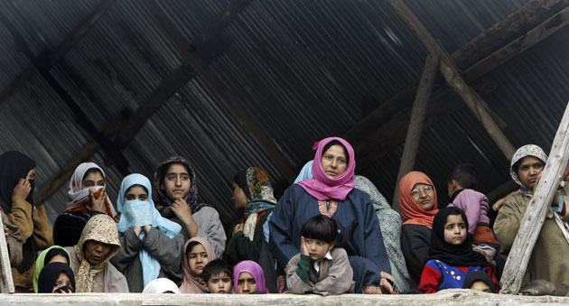 25 March 2009: Dab, India: Women watch the funeral procession of Shabir Ahmed Malik