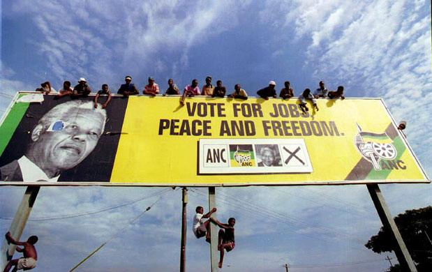 Chris McGreal's Africa: ANC supporters wait for Nelson Mandela on a billboard in a township 1994.