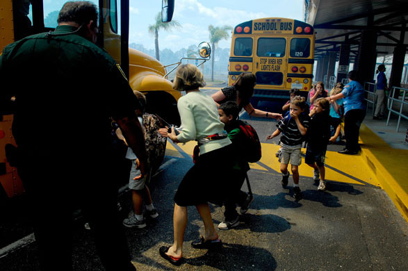 26 March 2009: Students from Felix A Williams Elementary School are evacuated onto buses