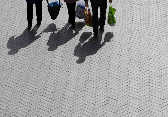Week in Business: The shadows of shoppers are cast onto the ground in Birmingham