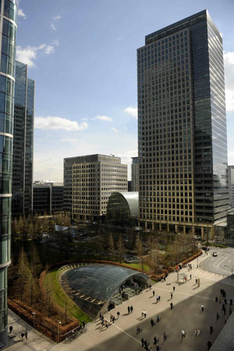 Week in Business: Pedestrians walk in the financial district of Canary Wharf in London