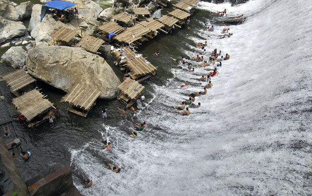 24 hours in pictures: Montalban, Philippines: Filipinos enjoy the cool waters coming from a dam