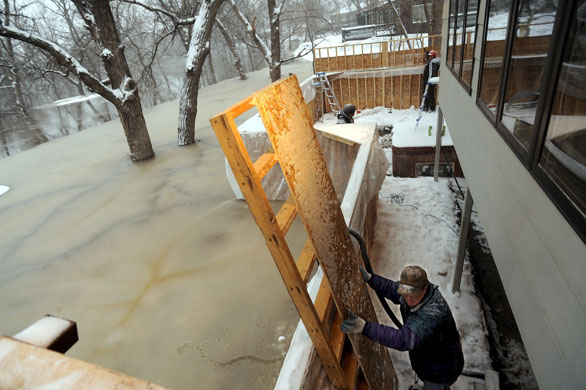 Red River floods: Brian Witthoeft works to keep out the rising Red River flood waters