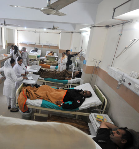Shooting in Lahore: Injured policemen are attended by medical staff at a hospital