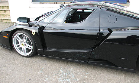 Jay Kay's black Ferrari Enzo with its shattered driverside window