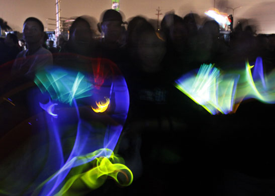 Earth Hour: People wave their glow sticks Earth Hour  in Manila, Philippines