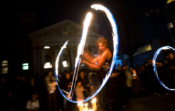 Earth Hour: A fire acrobat performs in front of the National Theatre in central Sofia