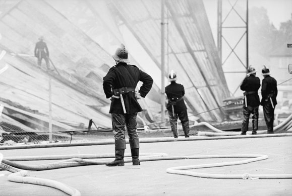 Firefighter uniforms: 1965: Firemen at the site of the Bowaters packaging factory fire in Croydon