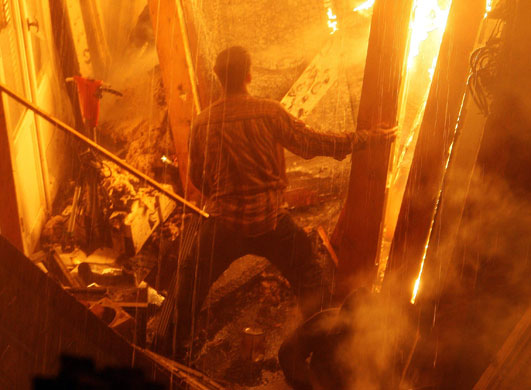 24 hours in pictures: A man is surrounded by a fire at the Friday market in southern Cairo