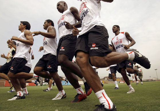 Sport: 24 hours: Peru's soccer players warm up during a training session