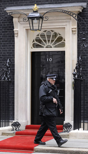 G20: An armed police officer passes the front of 10 Downing Street