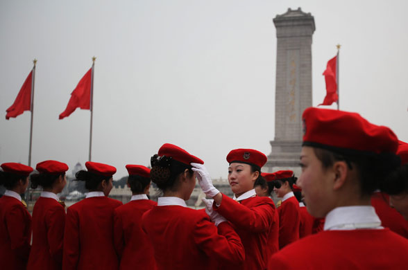 4 March 2009: Beijing, China: Hostesses adjust their hats at Tiananmen Square