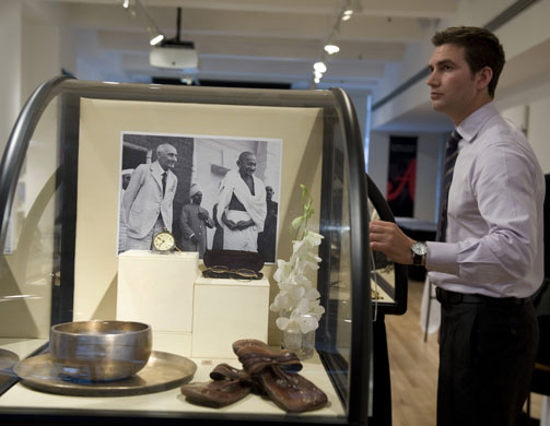 Mahatma Gandhi auction: An employee of Antiquorum Auctioneers stands with Mahatma Gandhi's items.