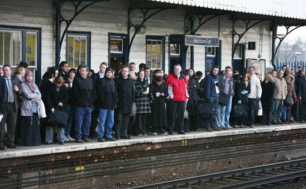 Snow in March: Commuters wait on the platform at Maidstone East Railway Station.
