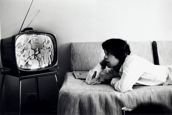 Beatles and Stones: Mick Jagger watches TV during a tour in the US. 