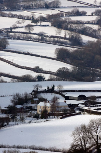 Snow in March: Snow covers fields surrounding a farmhouse near Chard in Somerset