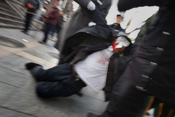 24 hours in pictures : A protestor is carried away by police at Tiananmen Square, China