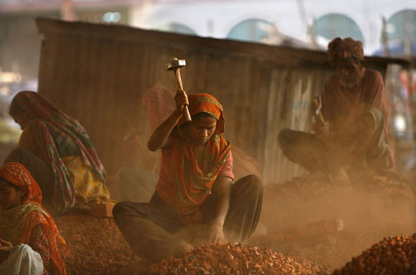 8 March 2009: Dhaka, Bangladesh: Women smash bricks at a construction site