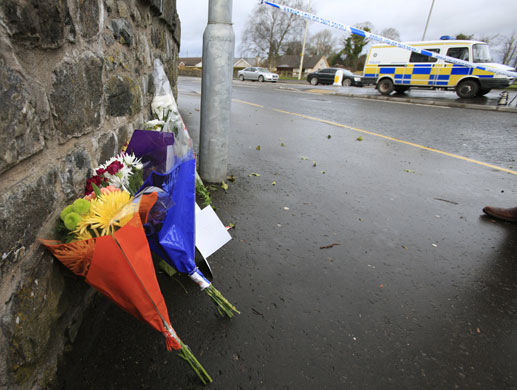 Northern Ireland shooting: Flowers near the entrance of Massereen Army base