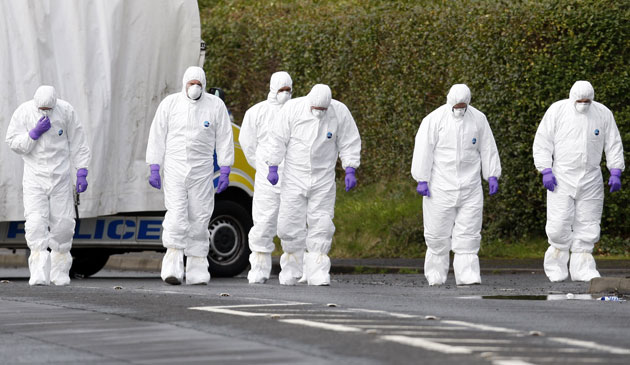 Northern Ireland shooting: Police forensic officers examine the scene