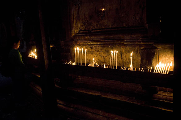24 hours in pictures: A Christian lights candles at the Church of the Holy Seplulchre