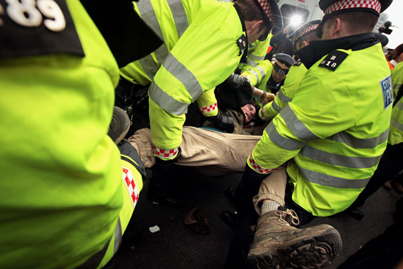 1 April 2009: London, UK: A G20 demonstrator struggles with police during in Bishopsgate