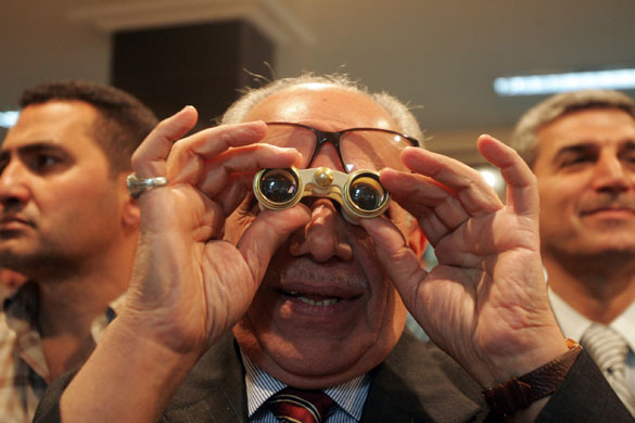 1 April 2009: Baghdad: An investor looks at the dealing board at the Stock Exchange