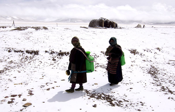 1 April 2009: Dangxiong country, China: Women carry drinking water