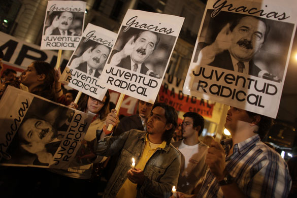 1 April 2009: Argentina: People holding posters with the image of Raul Alfonsin