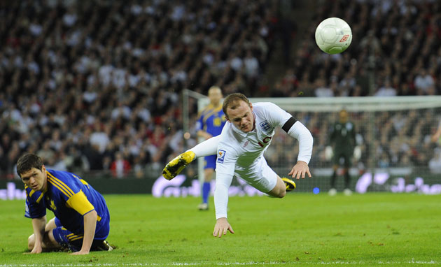 England v Ukraine: Wayne Rooney flies through the air after being fouled