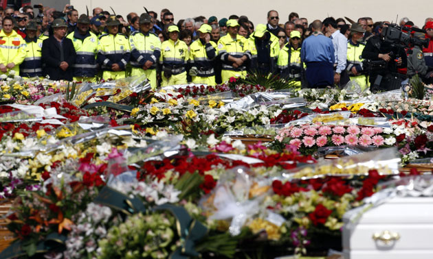 Italy earthquake funerals: Coffins adorned with flowers are lined up during the funerals
