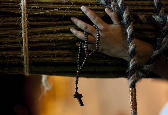 24 hours in pictures: Taxco, Mexico: A man carrying a bundle of cactus on his shoulders.