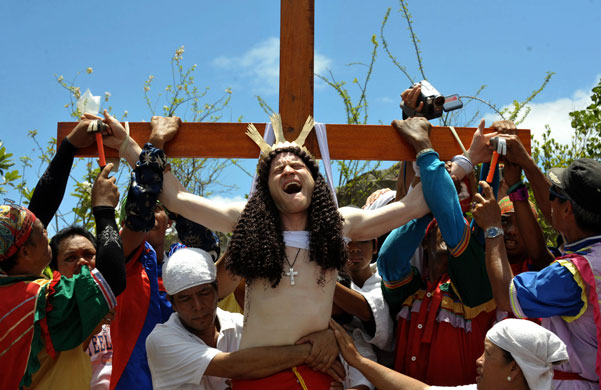 24 hours in pictures: Kapitangan, Philippines:  John Michael has his hands nailed to the cross