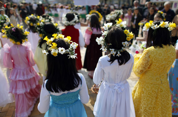 24 hours in pictures: Pitesti, Romania: Girls wear spring flowers crowns at a parade.
