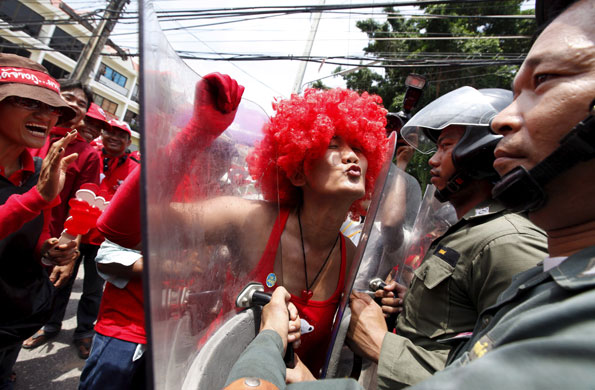 24 hours in pictures: Pattaya, Thailand:  A Thai red shirt protester dressed in a red wig