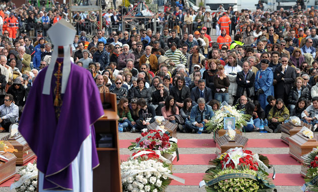 Earthquake victim funeral: Cardinal Tarcisio Bertone reads at the funeral for the Earthquake victims