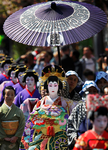 24 hours in pictures: Tokyo,  Japan: A woman in authentic costume enacts Oiran