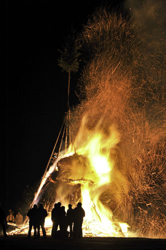 24 hours in pictures: Elbingerode, Germany: People stand in front of an Easter bonfire