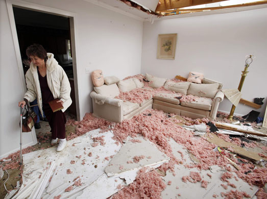 24 hours in pictures: Tennessee, USA: A woman returns to her tornado-damaged home